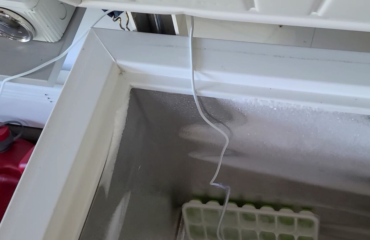 The iSocket Temperature Sensor Specific is positioned in the chest freezer, with the cable running at the hinges location.